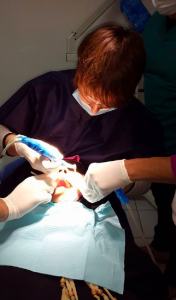 Dentists working on a patient to give them straight teeth in six months