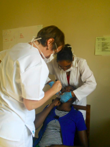 Two North London dentists performing general dentistry on a child in Tanzania