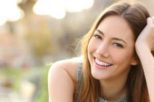 Woman in park smiling with beautiful smile