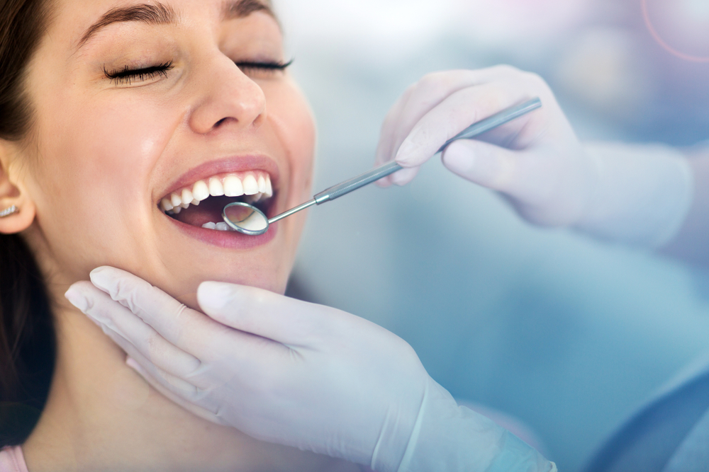 A smiling woman receiving a dental treatment